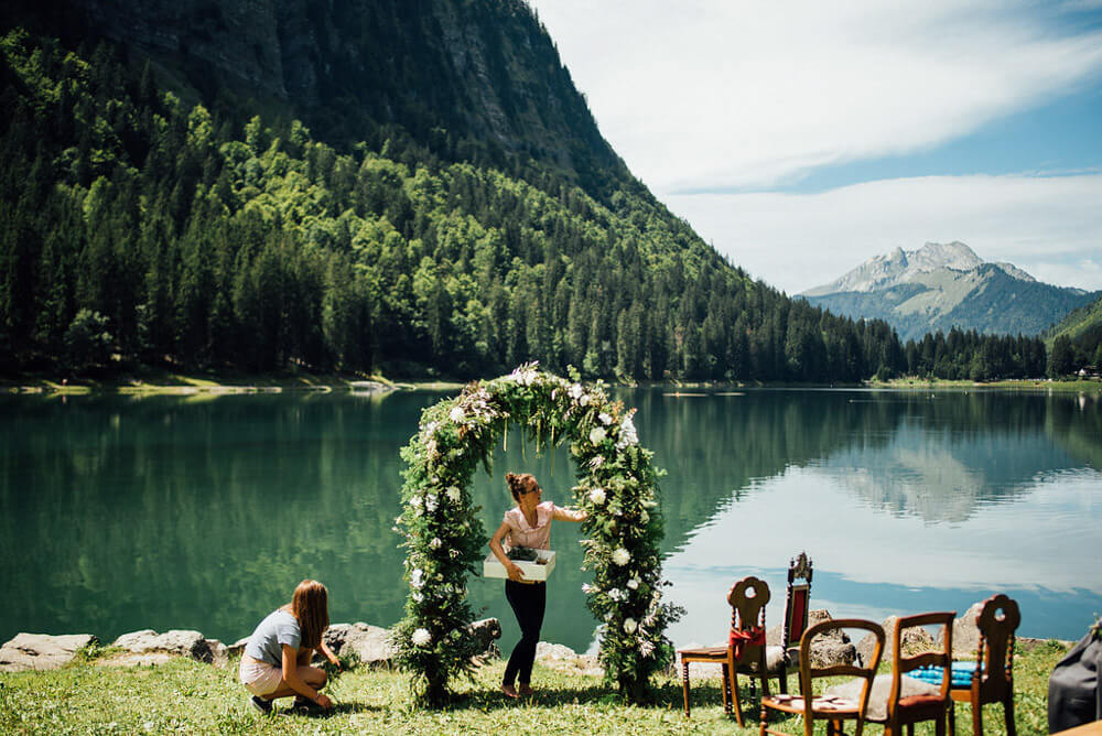 Florist setting up the flower arch for a ceremony at Lake Montriond in the French Alps